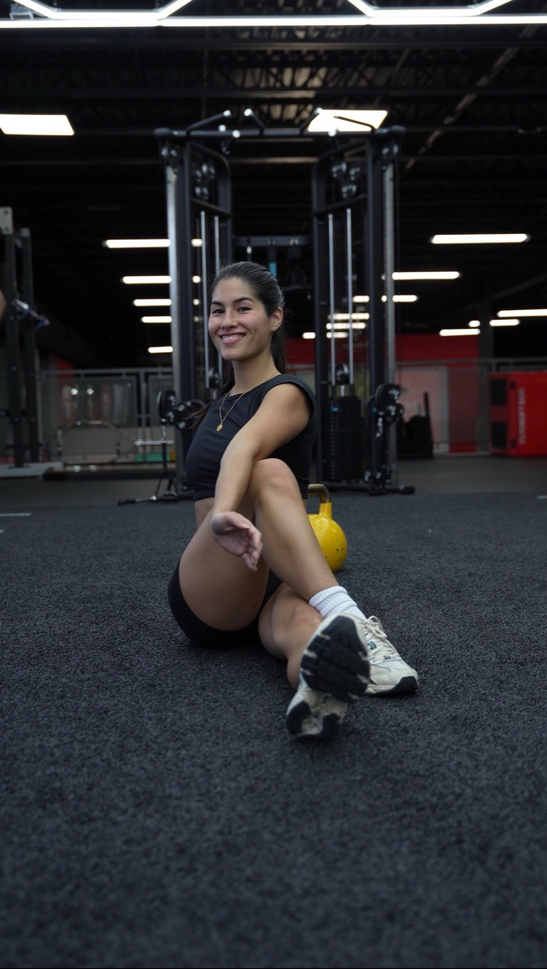 Charlotte on the gym floor with a kettlebell