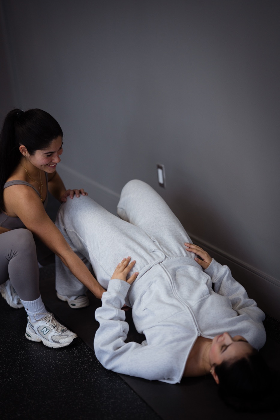 Charlotte coaching a 1:1 client through a glute bridge